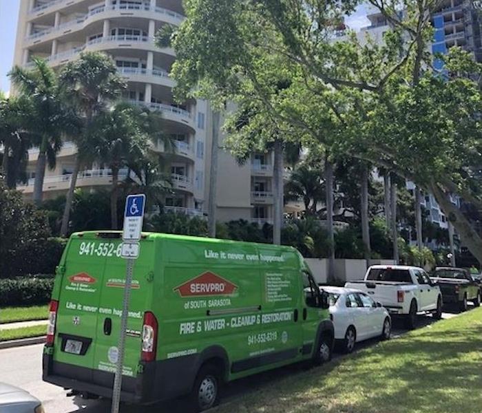 SERVPRO green fleet vans in front of a commercial property