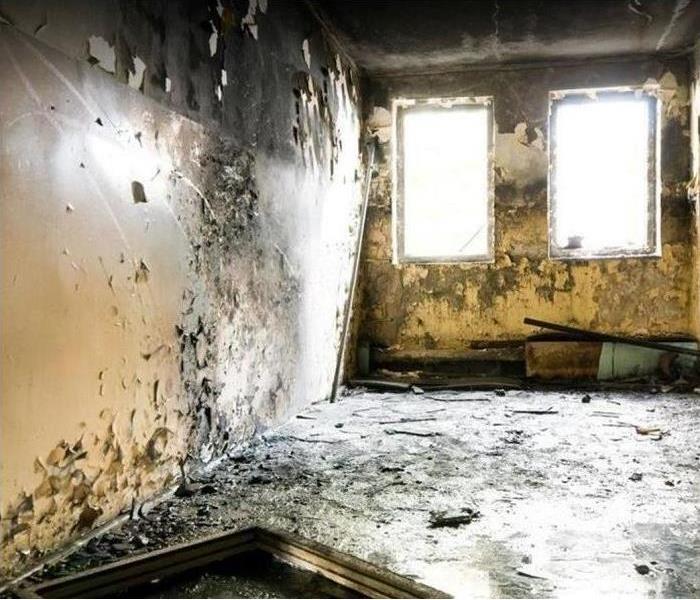 Fire damaged room; smoke and soot on walls