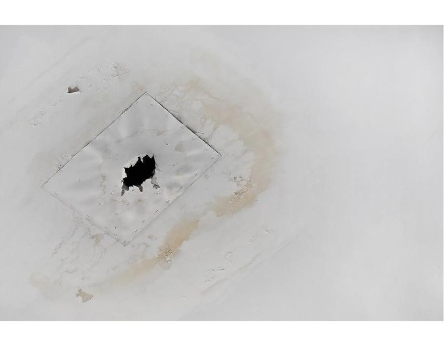 Water damaged ceiling; water stains on ceiling; hold drilled for drainage