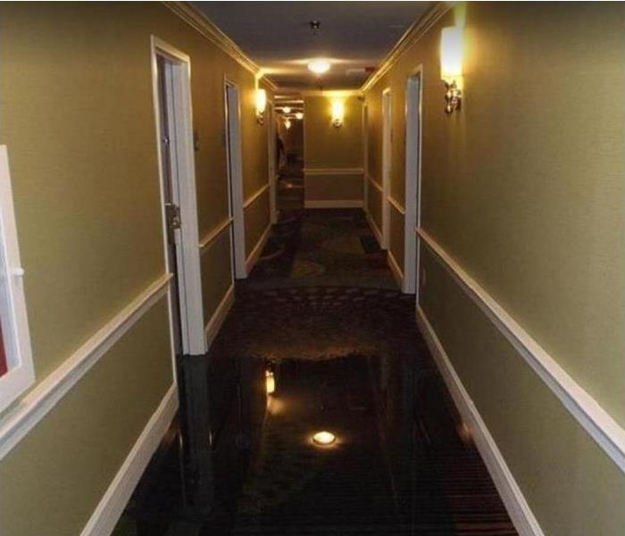 Standing water in hallway of hotel