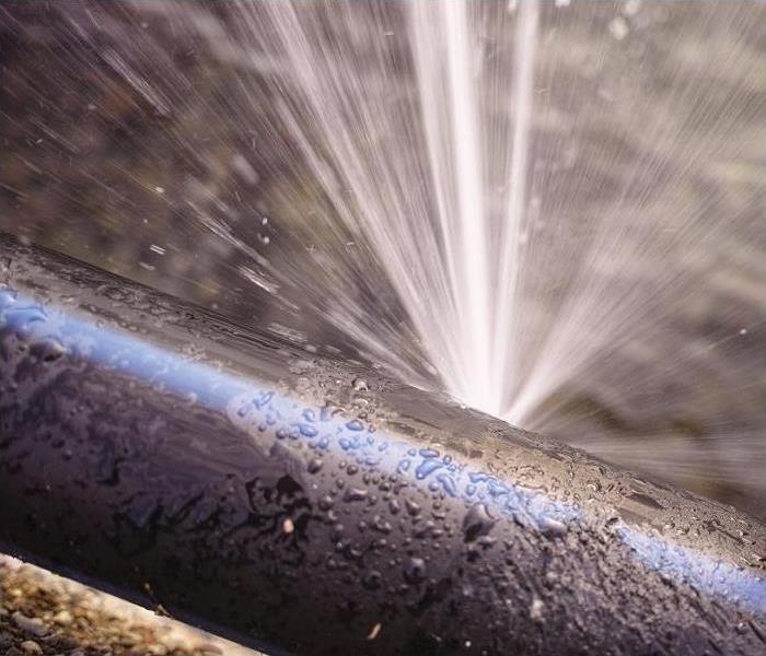 Water spewing from pipe.