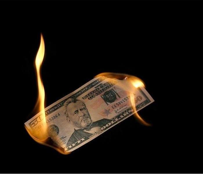 $50 bill burning on both ends