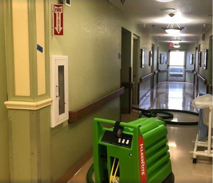 SERVPRO restoration equipment being used in a business, equipment in hallway.