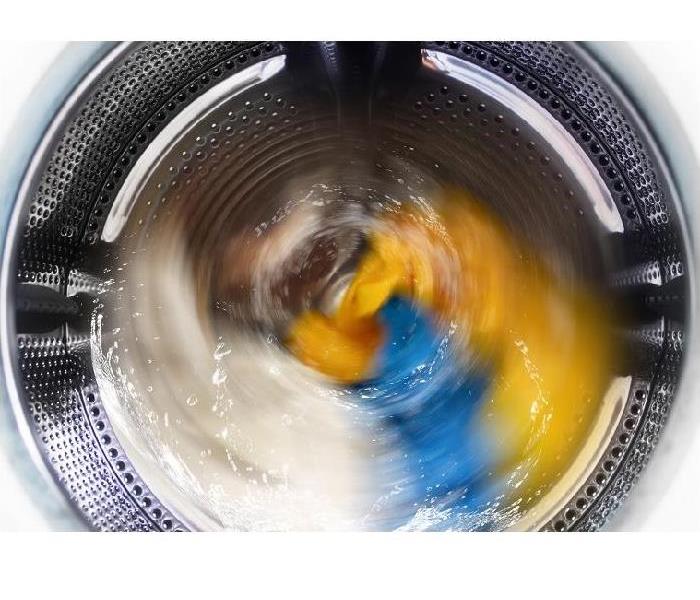 Clothes spinning in washing machine.